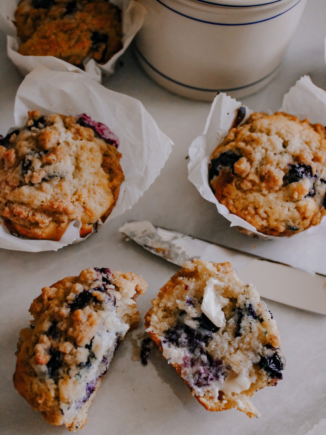 Blueberry muffins with butter.